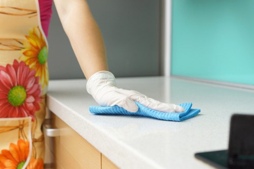 Housekeeper preparing a bedroom cleaning routine in Westkensington