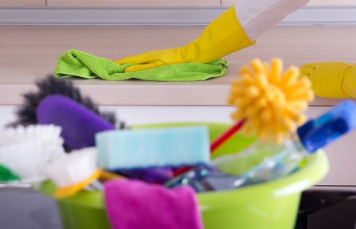 Office cleaners sanitizing desks and shared surfaces in Westkensington