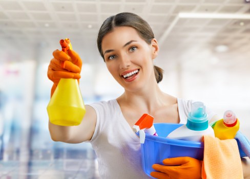 Cleaner wearing PPE and checking a safe workspace before starting