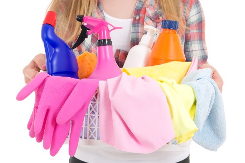 Protective gloves, apron, and cleaning supplies arranged safely
