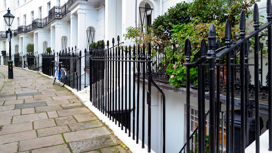 A rectangular street sign mounted on a brick wall, displaying the text 'WELCOME TO SOUTH KENSINGTON SW7' with 'SOUTH KENSINGTON' in large black letters, 'WELCOME TO' in smaller red letters above, and